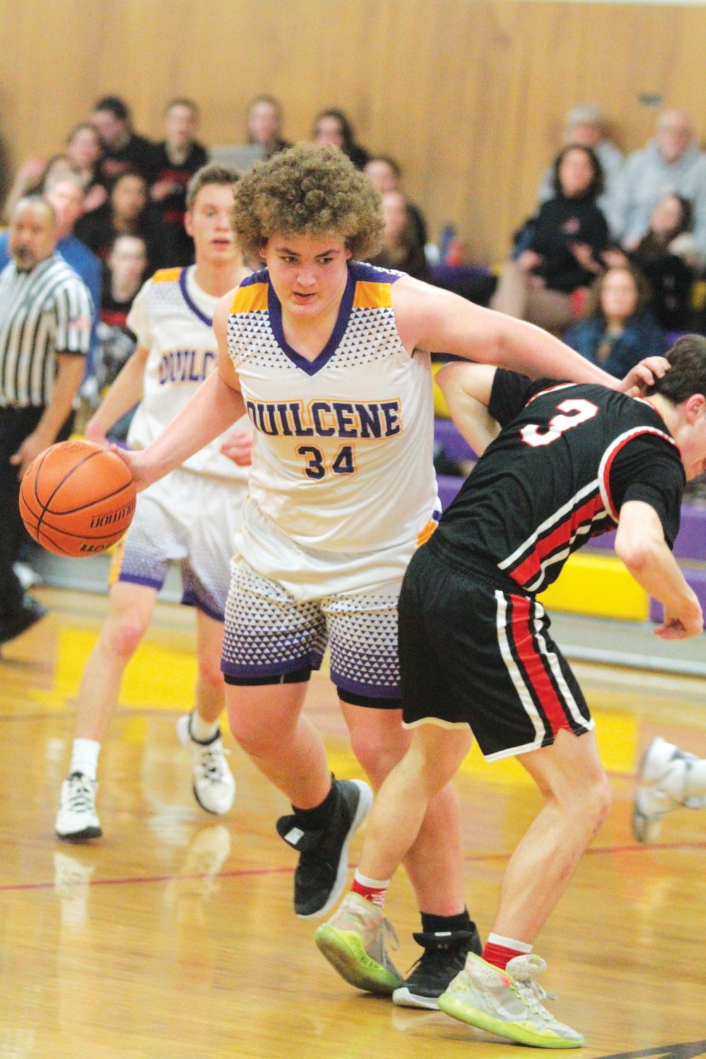 Taylor Boling creates some room in the lane by adjusting the position of Silas Stenerson of Crosspoint Academy during the matchup late last week in Quilcene.